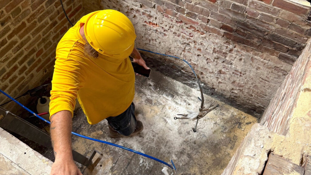 Polyurethane Permeation Grout Injections Stabilize Bank Expansion Elevator Shaft in Downtown Tampa 4 Injecting permeation grout inside elevator shaft