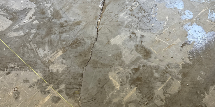 Cracked concrete slab in a commercial warehouse.
