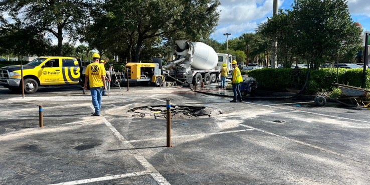 Helicon crew compaction grouting in a plaza parking lot.