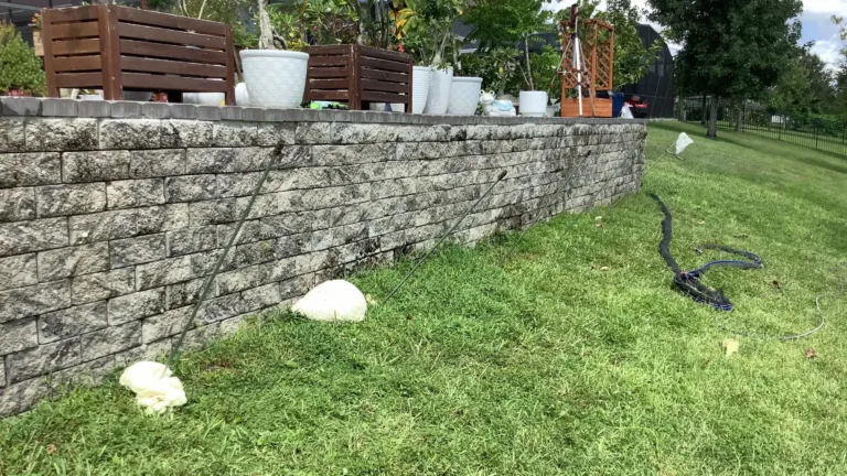 Helicon ground improvement project showing retaining wall stabilization with injection rods installed along residential landscape