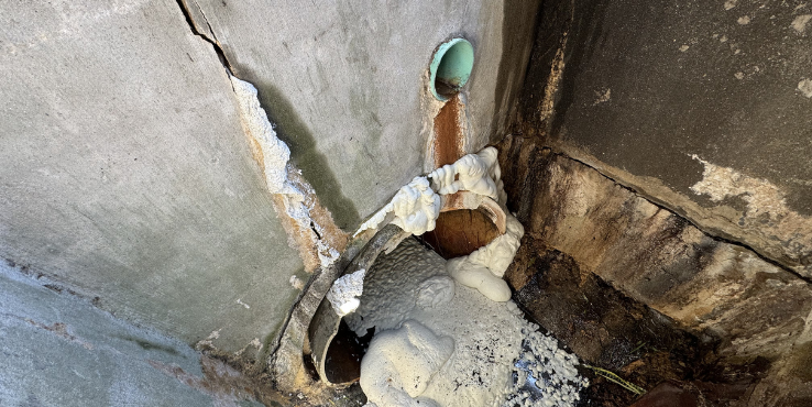 Chemical grout seeping through the crack in the stormwater infrastructure