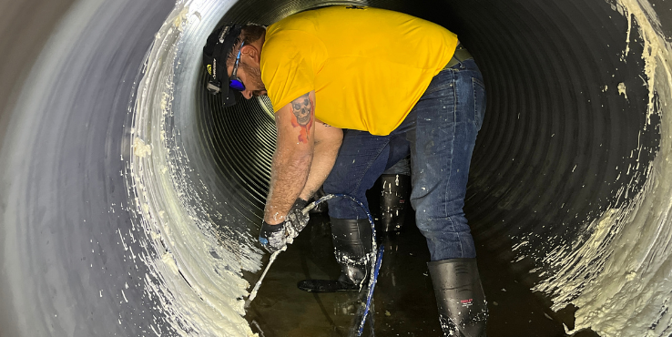 Helicon crew member doing chemical grout injection points inside of a tunnel